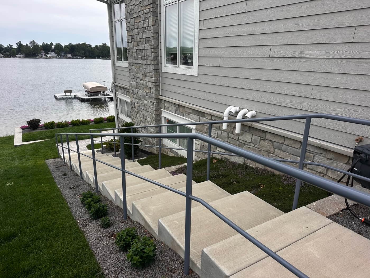 Concrete steps with metal railing leading to a Southwest Michigan lakefront